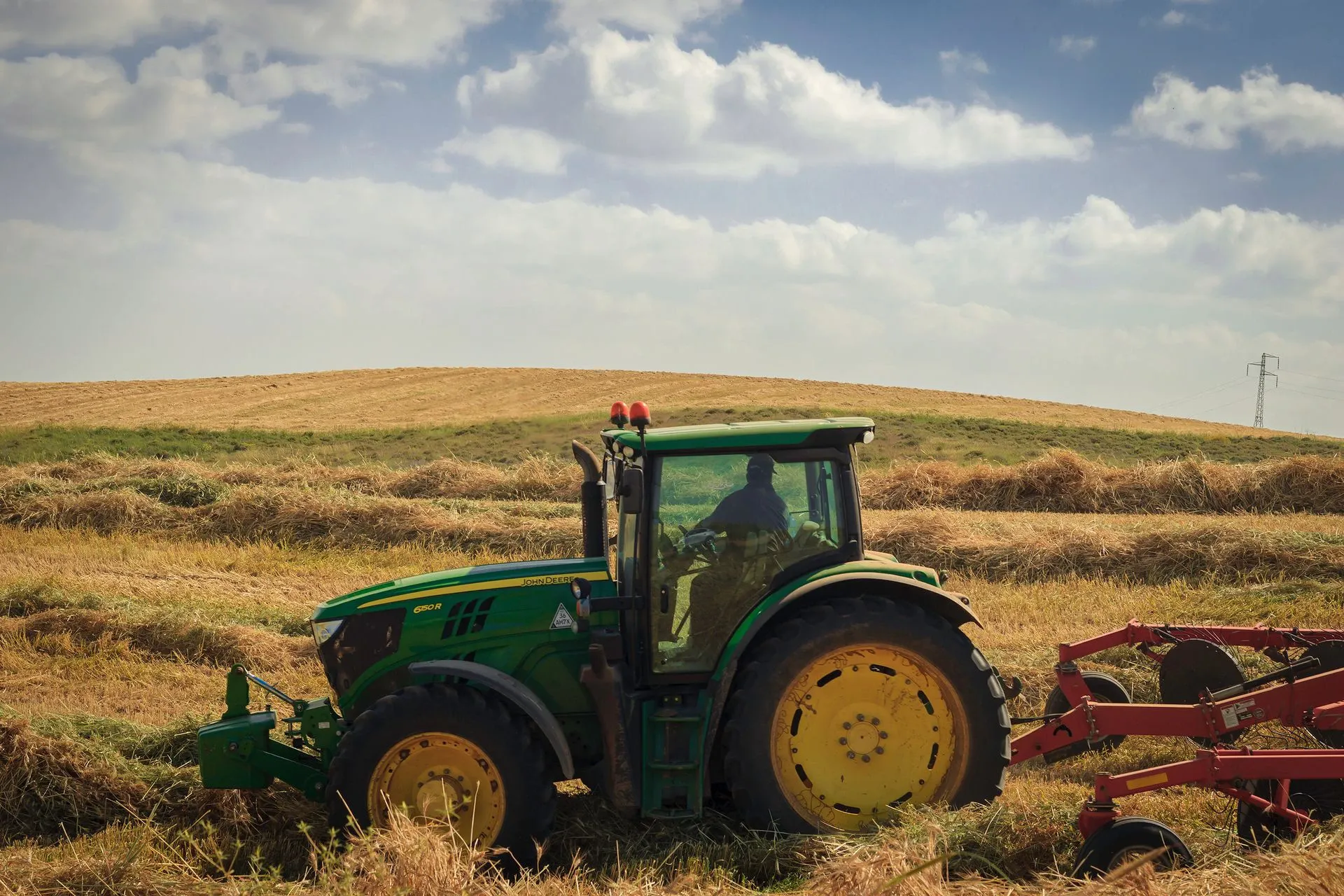 Tractor and cultivator working a field.