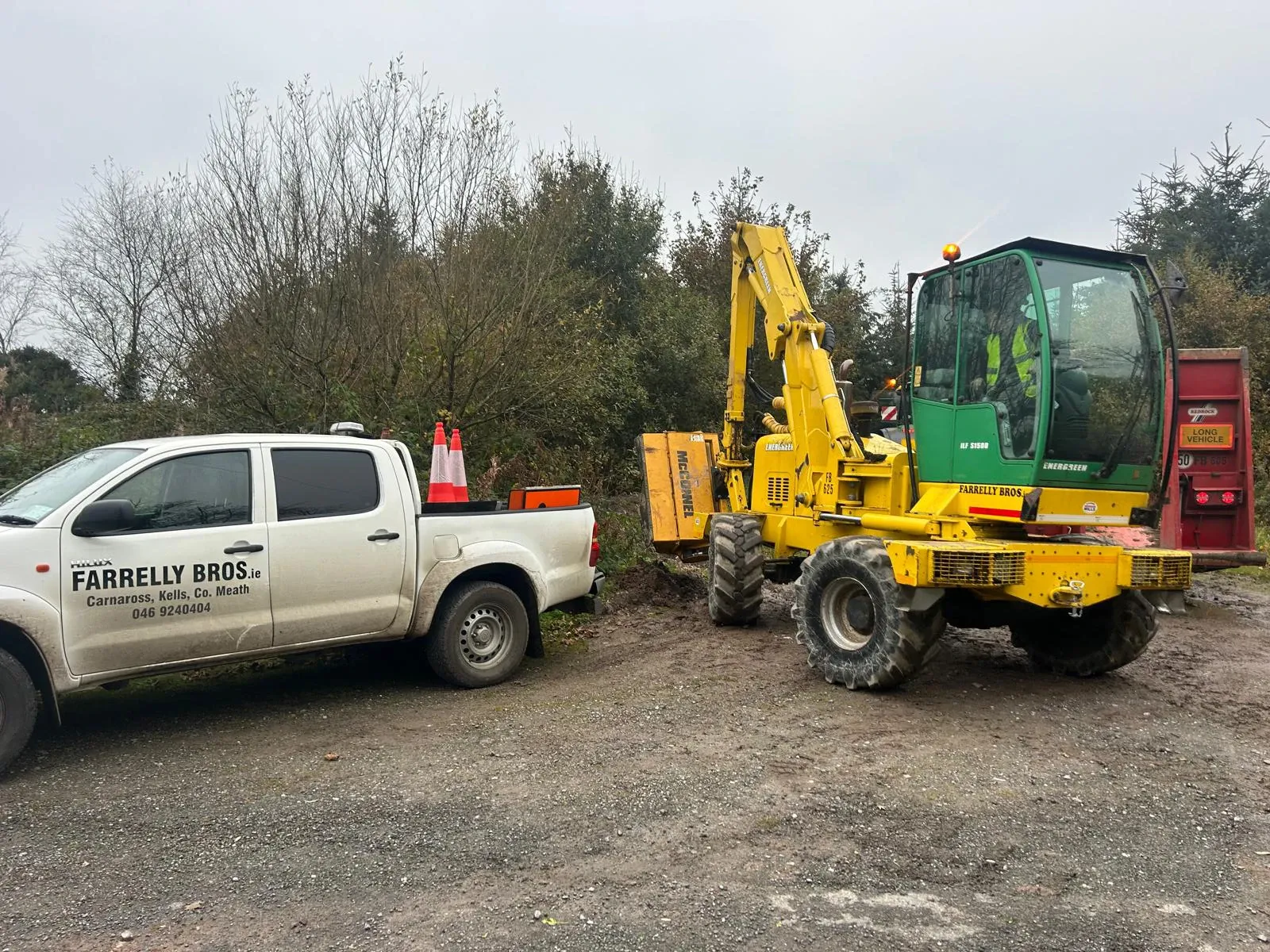 Farrelly Bros hedge-cutting arm clearing roadside growth, with the crew truck alongside.