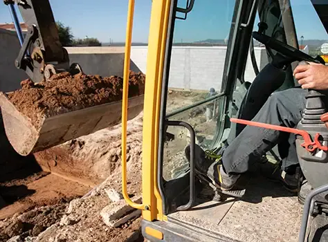 Excavator operator at the controls.